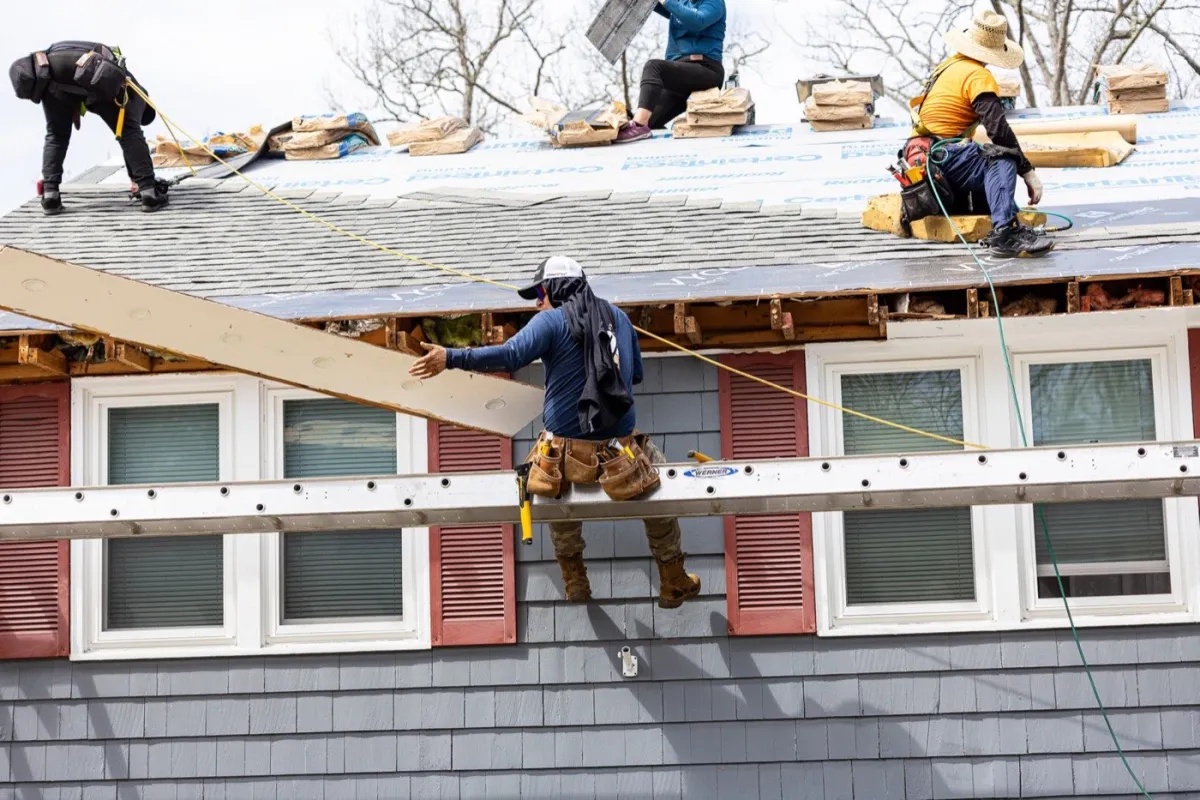 Senco Home Services crew installing a new asphalt shingle roof on a Massachusetts colonial home